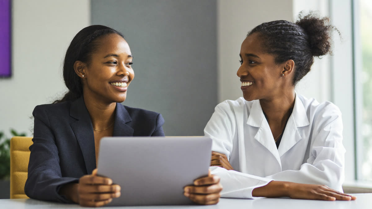 A consultant shows a dental practice owner an agent setup on a tablet